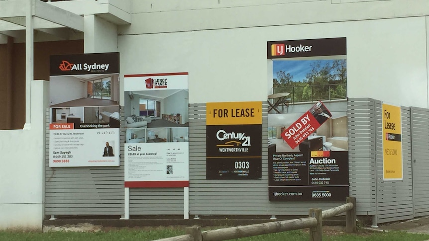 For lease and for sale signs proliferate outside an apartment block in the western Sydney suburb of Westmead