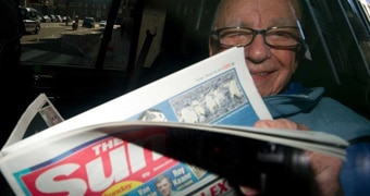 Rupert Murdoch reading The Sun newspaper