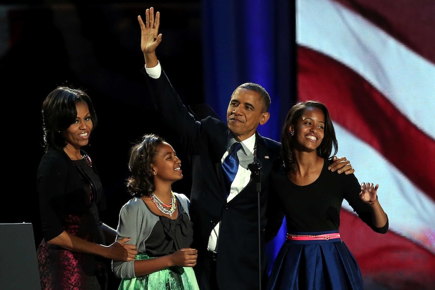US president Barack Obama walks on stage with first lady Michelle Obama and daughters Sasha and Malia.