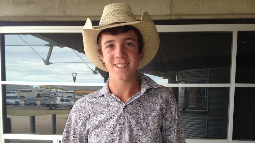 14 year old Daniel Guilford stands outside the Australian Equine and Livestock Events Centre in Tamworth in his cowboy gear.