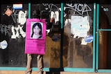 A man carries a photograph of a missing 14-year old girl in Ciudad Juarez