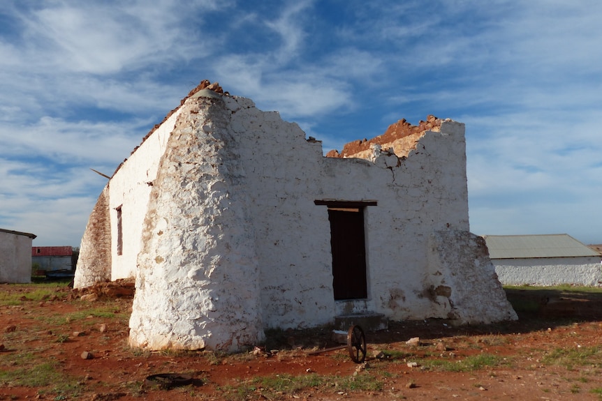 mud brick farm building made from rendered mud bricks which have fallen away partly