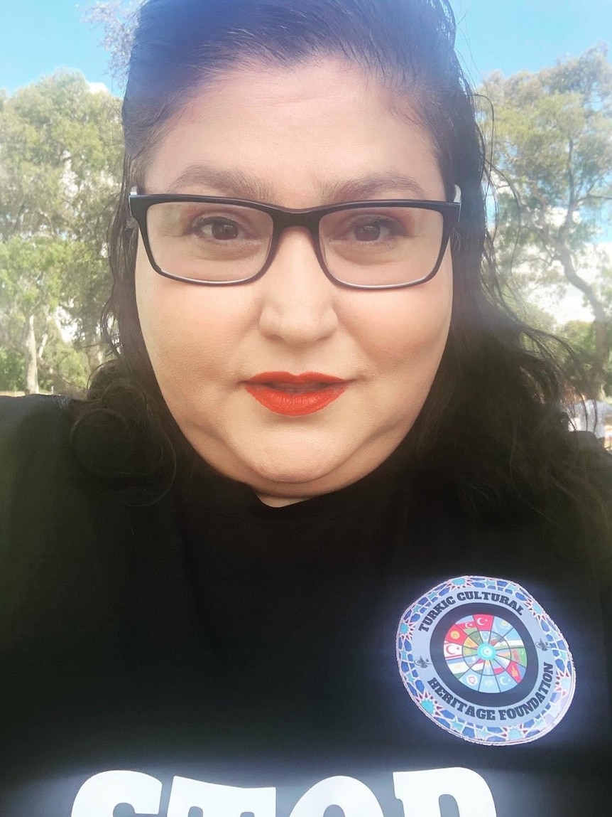 Selfie of a woman wearing a black t shirt and red lipstick