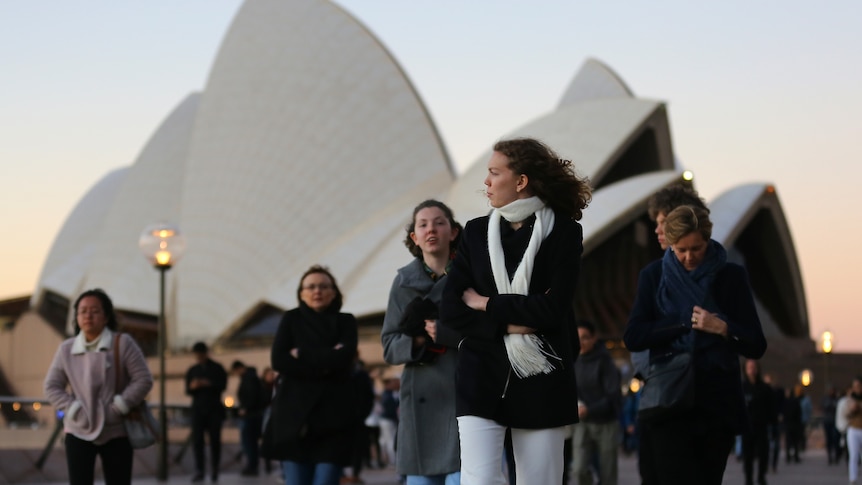 People wearing warm clothes outside Sydney Opera House