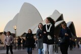People wearing warm clothes outside Sydney Opera House
