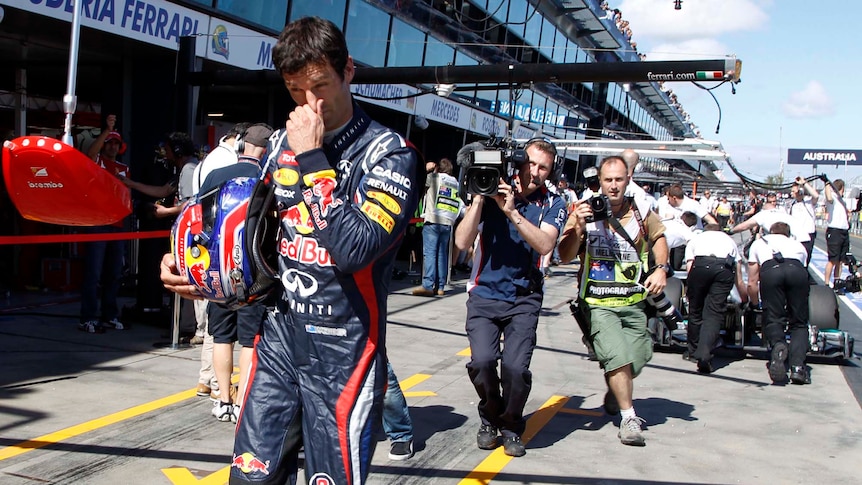 Red Bull driver Mark Webber walks in the pit lane