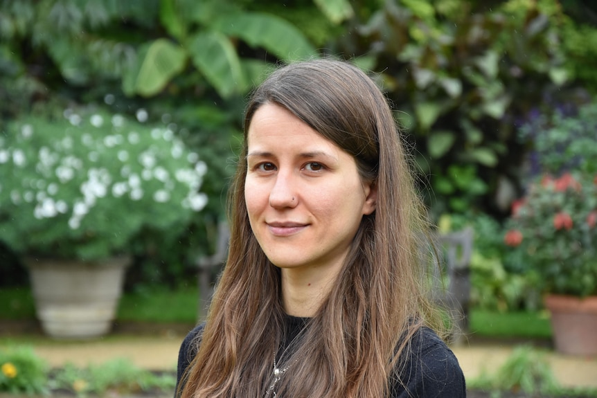 Portrait of a woman with a garden in the background