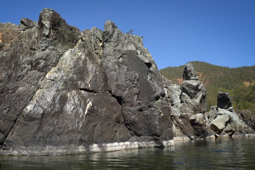 The Clarence River Gorge, view from a boat on the river looking at high rock walls on either side.
