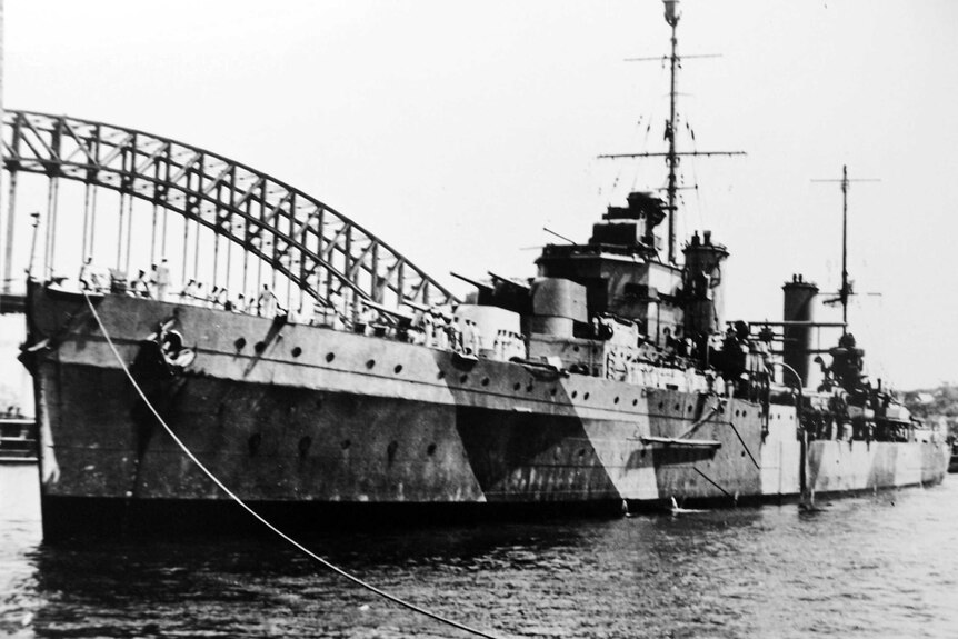 Black and white picture of a naval ship docked in Sydney Harbour