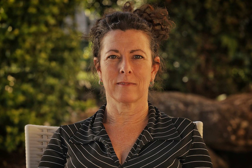 A woman wearing a black and white striped top.