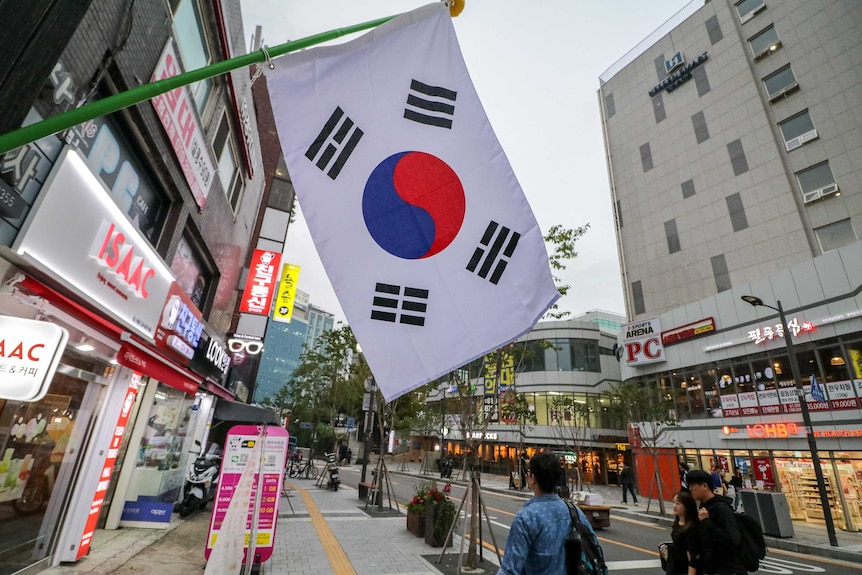 The Korean flag hangs from the side of a building