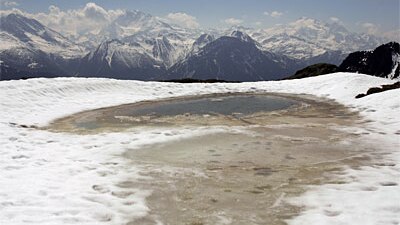 Melted water flows together, forming a pool near the Aletsch Glacier in April  2007 near Brig, Switzerland.