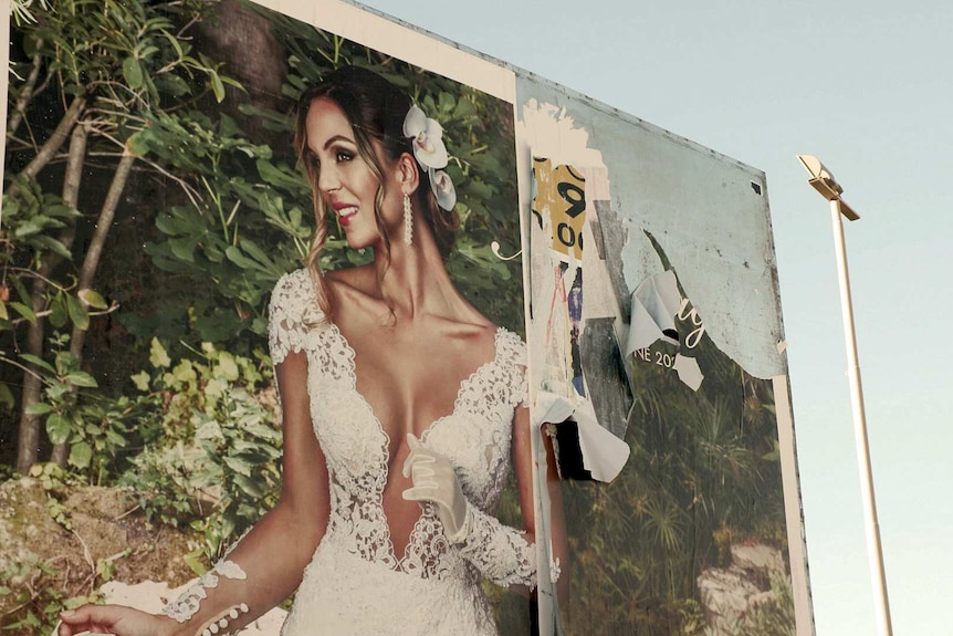 A torn billboard poster in Castel Volturno.