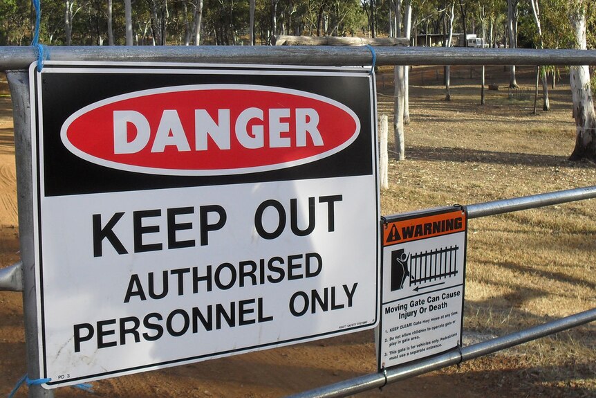 A quarantine sign hangs on a metal gate