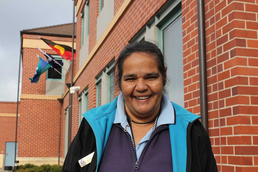 Albury Aboriginal Community Liason Officer, Alison Reid looks directly at the camera, standing in front of the police station.