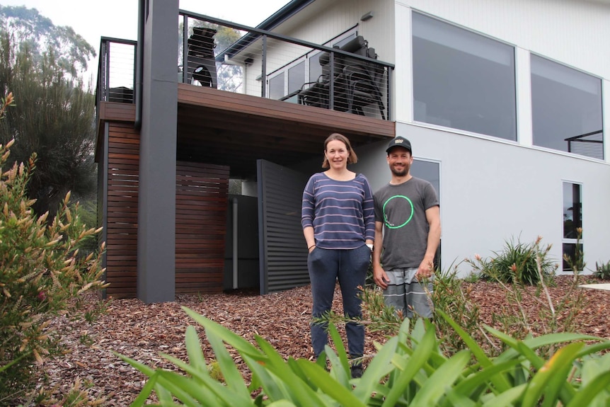 Louise and Mark Padgett at the front of their Coles Bay holiday home.
