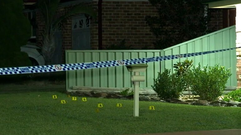 police tape outside a suburban home at night