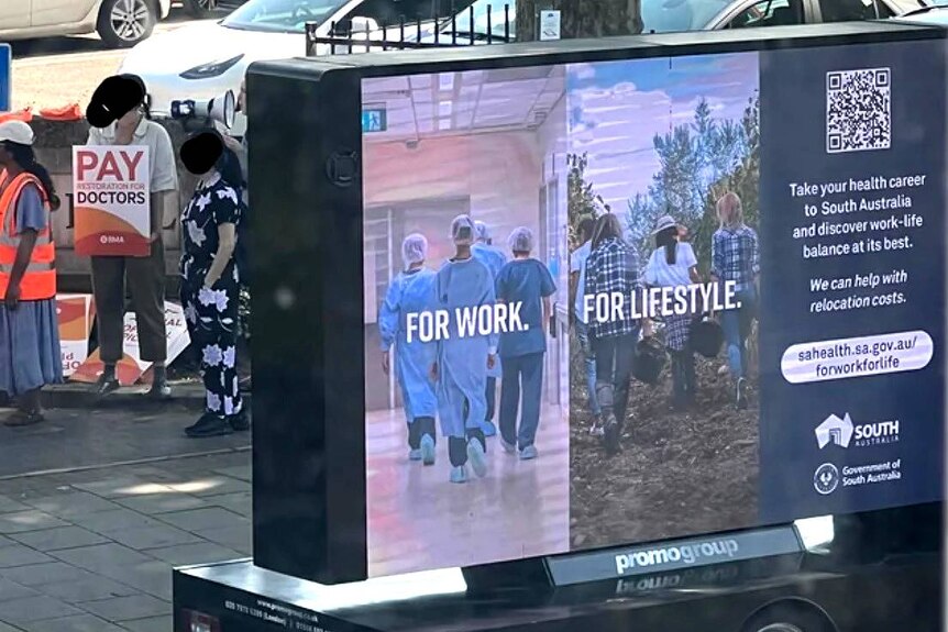 A job recruitment billboard outside a doctors strike.