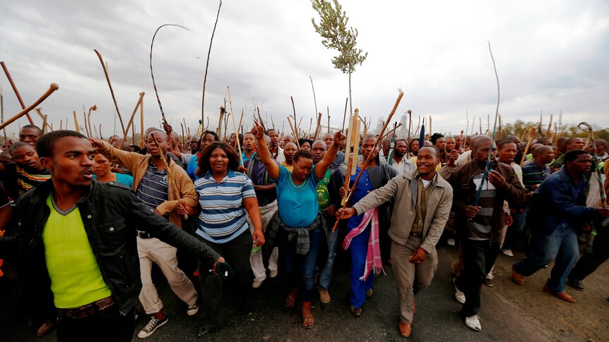 Workers take part in a march at Lonmin's Marikana mine in South Africa