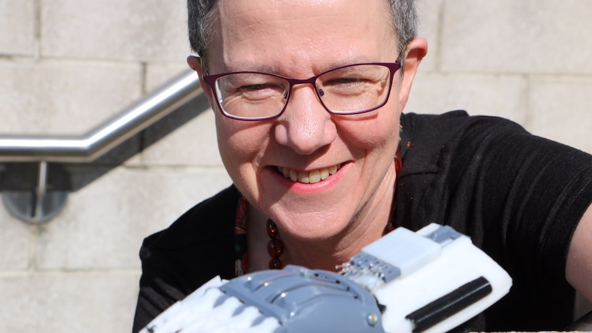 Dr Marie-Louise Ayres shows a 3D printed prosthetic hand produced by staff at the National Science and Technology Centre.