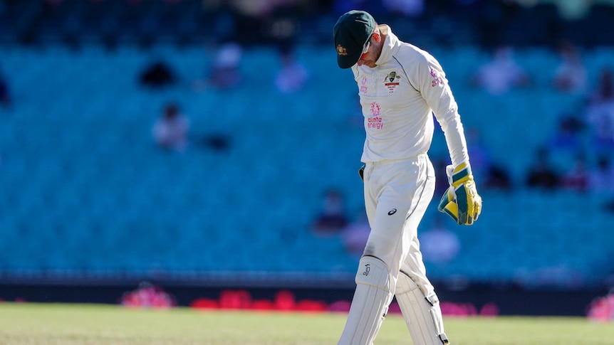 Australia wicketkeeper Tim Paine walks with his head hung after the third Test against India at the SCG.