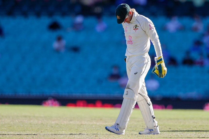 Australia wicketkeeper Tim Paine walks with his head hung after the third Test against India at the SCG.