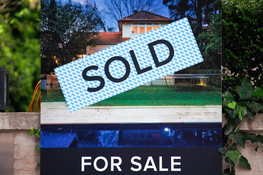 A real estate 'sold' sign outside a house in Sydney.