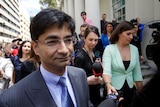 A tight head a shoulders shot of Lloyd Rayney with reporters and a crowd of people following him outside court.