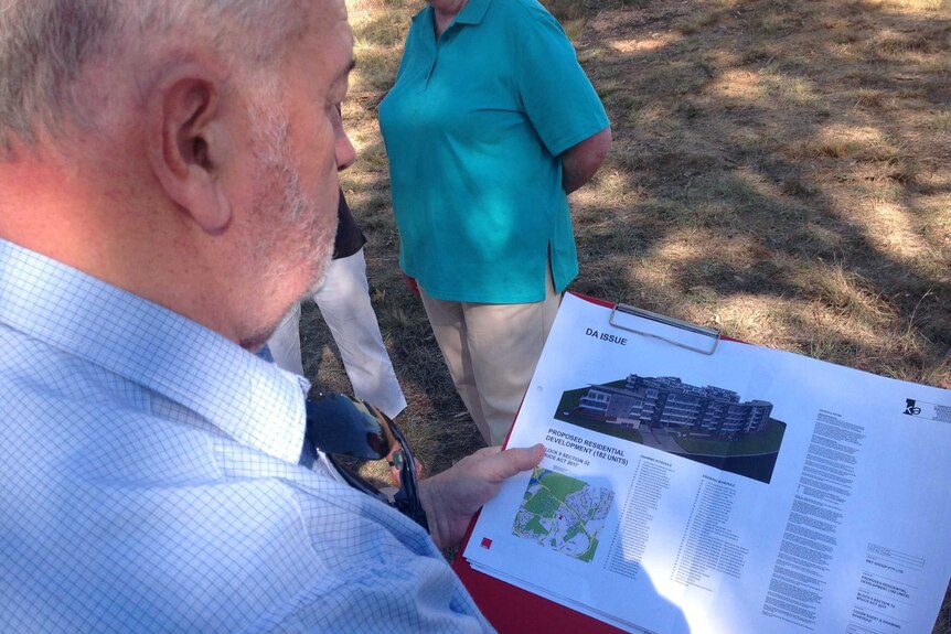 Canberra resident Bill Duncan with the defeated plan for a five story residential development in Bruce.