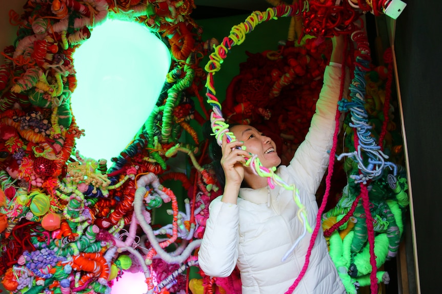 Japanese-Australian artist Hiromi Tango working on one of her works that uses textiles and projection.