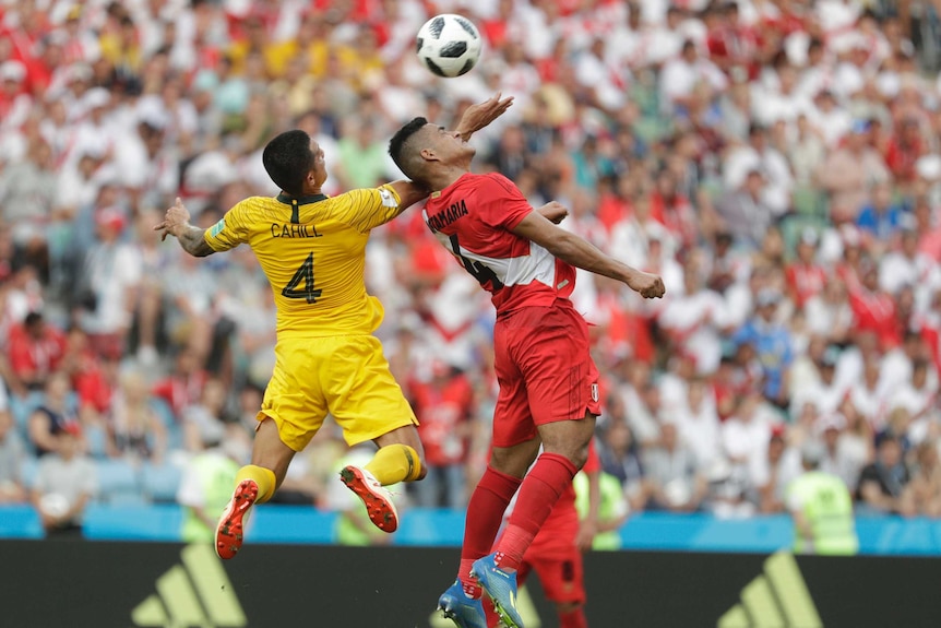 Australia's Tim Cahill, (L) and Peru's Anderson Santamaria are airborne at the World Cup in Russia.