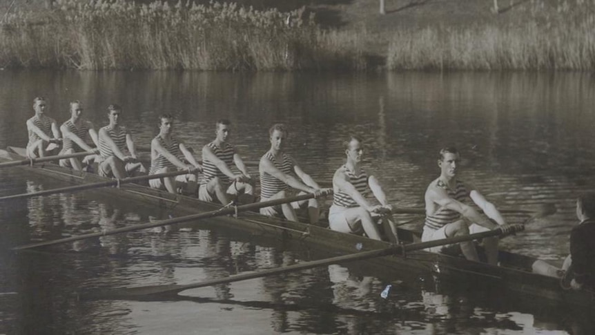 Portrait photo of rowers in boat on river