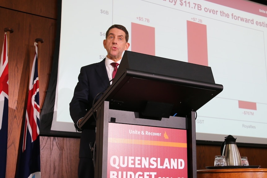 Queensland Treasurer Cameron Dick with budget 2021-22 projections behind him