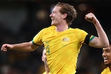 A Socceroos player pumps his left fist as he celebrates a goal in Lebanon.
