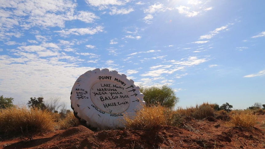 A sign pointing to the remote Lake Mackay.