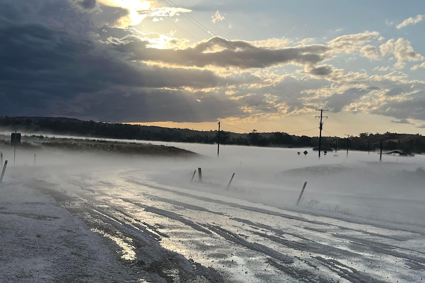 A road covered in hail and fog