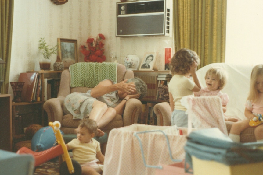 An old image of a family hanging out in a living room