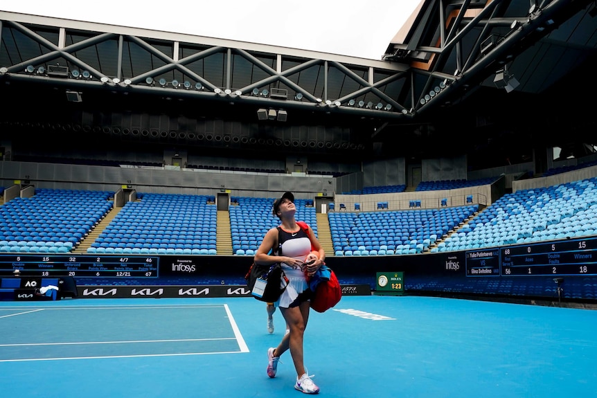 Elina Svitolina walks off Rod Laver Arena in front of an empty grandstand.