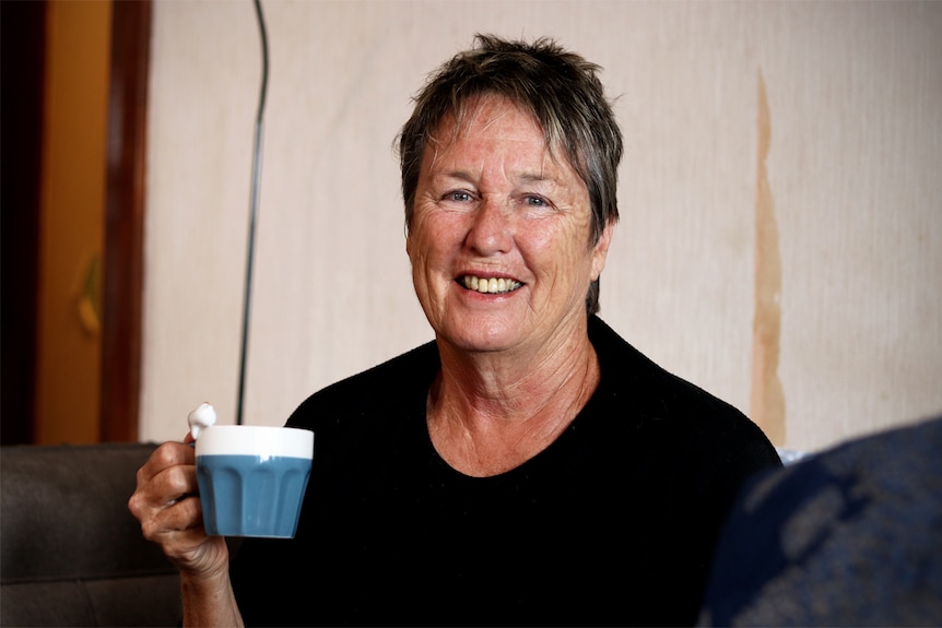 Robynne Murphy drinks a cup of coffee.