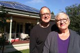 Warwick and Lola Neilly posed outside their Melbourne home which is powered by solar panels