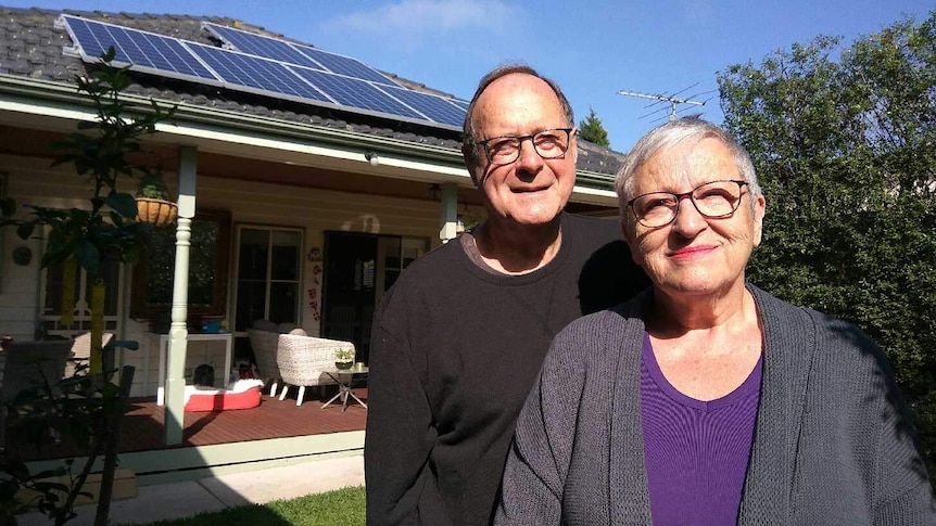 Warwick and Lola Neilly posed outside their Melbourne home which is powered by solar panels