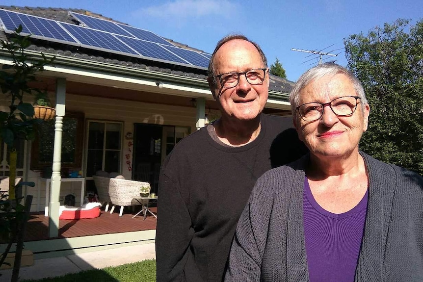 Warwick and Lola Neilly posed outside their Melbourne home which is powered by solar panels