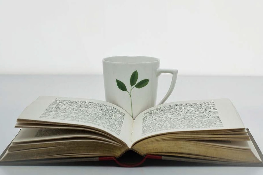 An open book and a cup
