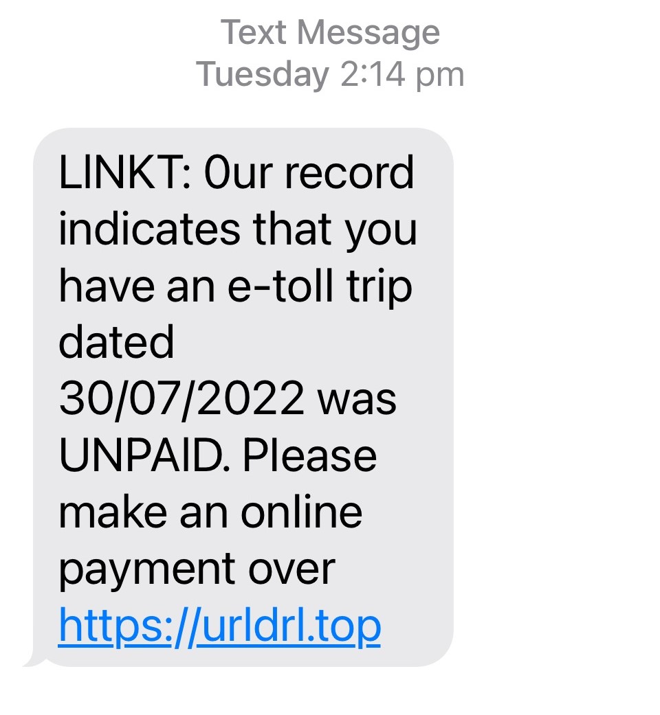 A screenshot of a text claiming the recipient has an unpaid e-toll bill, with a URL link at the bottom of the message. 