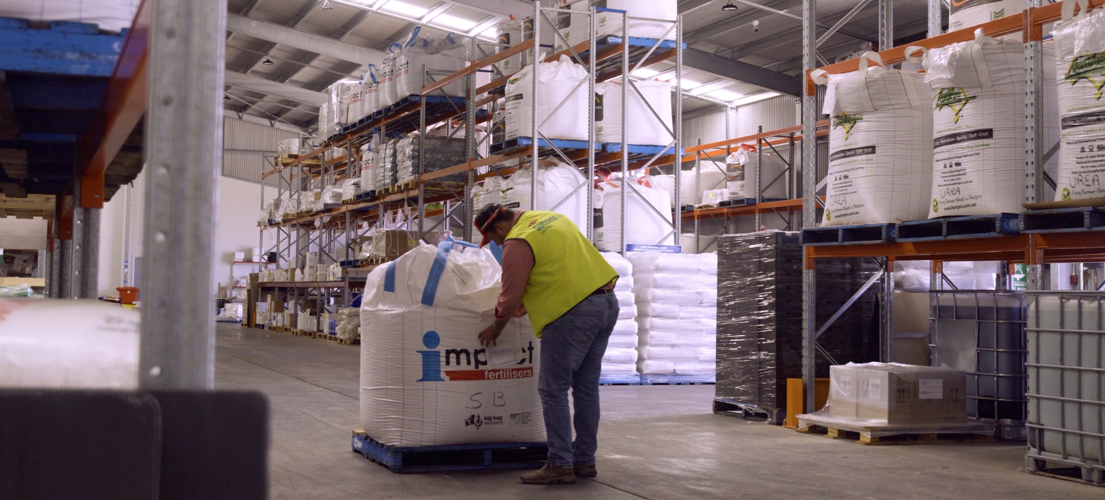 Worker near fertiliser bag