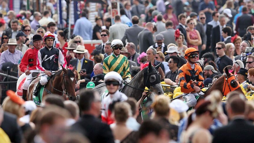 Jockeys leave the mounting yard at Flemington racecourse on Melbourne Cup day on November 6, 2012.
