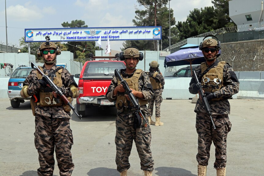 Uniformed Taliban special forces fighters stand guard outside Kabul airport