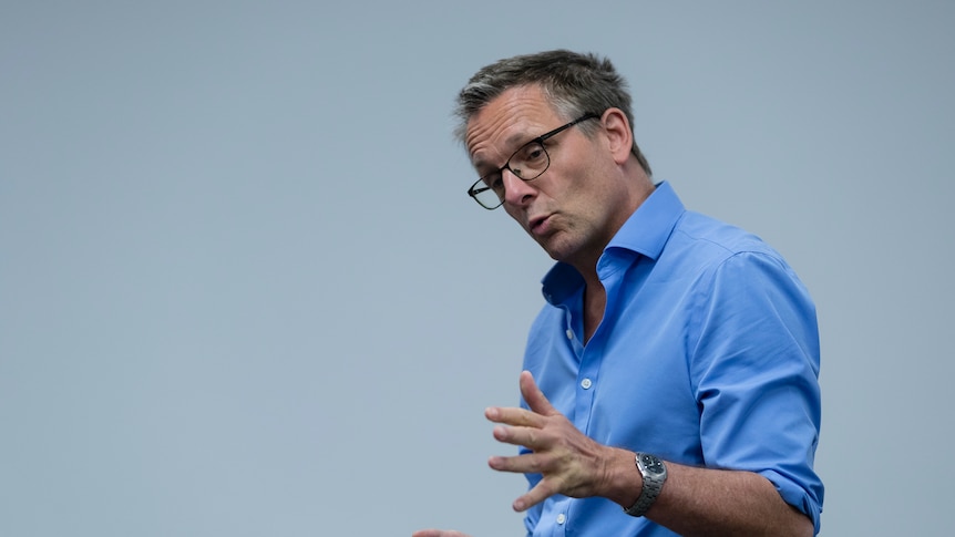 Michael Mosley speaks and gestures with his hands