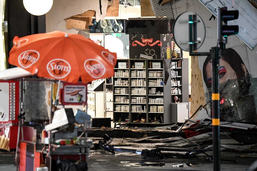 Damage to the department store Ahlens is seen after the beer truck was towed away in central Stockholm.