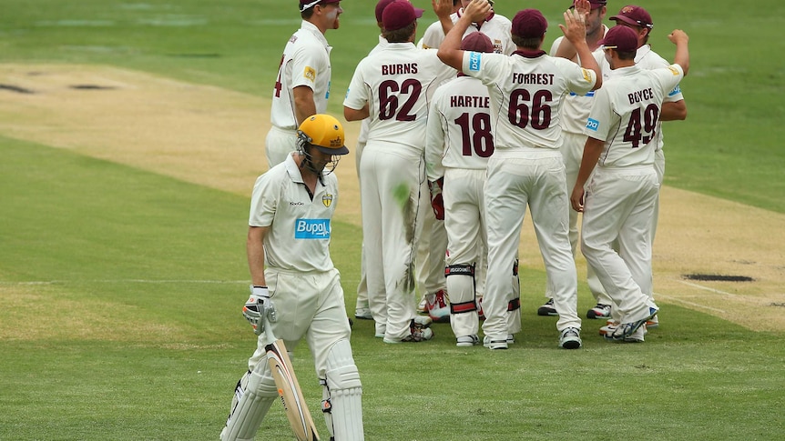 The Warriors' Adam Voges leaves the field after being dismissed by Queensland's Cameron Gannon.